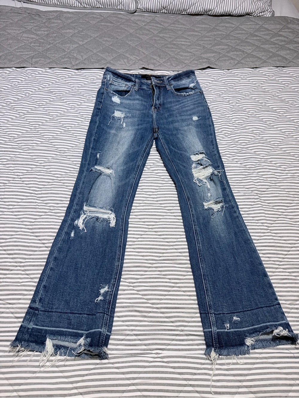 Distressed Blue Flare Jeans with Raw Hem